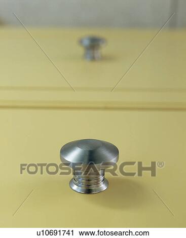 Stock Image - Close-up of chrome drawer handle. Fotosearch