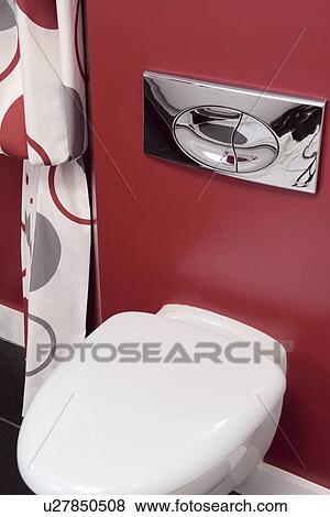 Stock Photo - Close-up of chrome flush above white toilet. Fotosearch