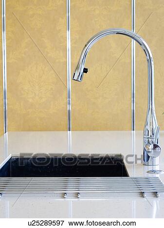Stock Photo - Close-up of chrome mixer-tap and underset sink. Fotosearch
