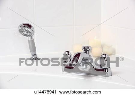 Stock Image - Close-up of chrome taps and shower-head. Fotosearch