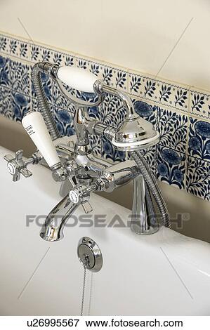Stock Photo - Close-up of chrome taps and shower-head. Fotosearch