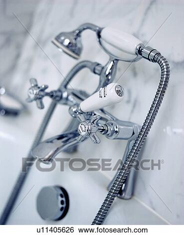 Close-up of chrome taps and showerspray View Large Photo Image Stock Photograph - Close-up of chrome taps and showerspray. Fotosearch