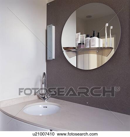 Close-up of circular mirror on grey wall above underset basin View Large Photo Image Stock Image - Close-up of circular mirror on grey wall above underset basin. Fotosearch