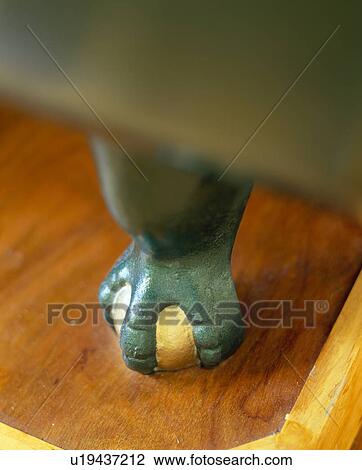 Stock Image - Close-up of claw foot on old bath. Fotosearch