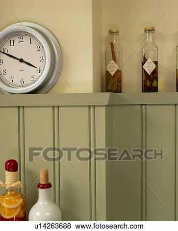 Stock Photo - Close-up of clock on grey tonque+groove panelling. Fotosearch