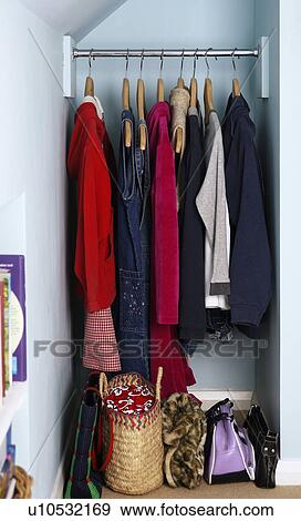 Close-up of clothes hanging on metal rail View Large Photo Image Stock Photo - Close-up of clothes hanging on metal rail . Fotosearch