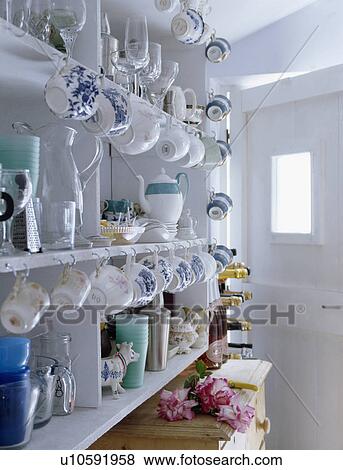 Stock Photo - Close-up of collection of antique china on white shelves. Fotosearch