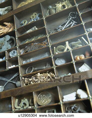 Picture - Close-up of collection of metal letters and keys in old print-tray. Fotosearch