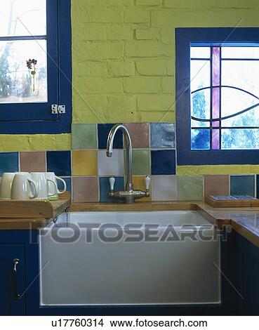 Close-up of colourful tiles and steel mixer tap above Belfast sink View Large Photo Image Picture - Close-up of colourful tiles and steel mixer tap above Belfast sink. Fotosearch