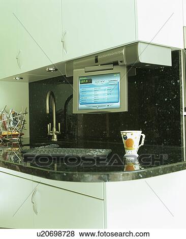 Close-up of computer keyboard and monitor on worktop in modern kitchen View Large Photo Image Stock Photo - Close-up of computer keyboard and monitor on worktop in modern kitchen. Fotosearch