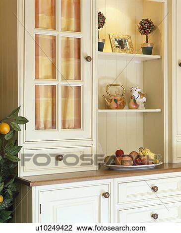 Close-up of cream fitted dresser with checked drapes inside glazed doors View Large Photo Image Stock Image - Close-up of cream fitted dresser with checked drapes inside glazed doors. Fotosearch