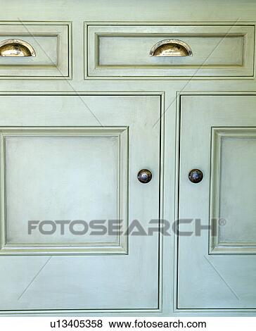 Stock Photo - Close-up of cream kitchen storage cupboard. Fotosearch