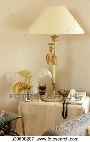 Close-up of cream lamp and telephone on small table View Large Photo Image Stock Photo - Close-up of cream lamp and telephone on small table. Fotosearch