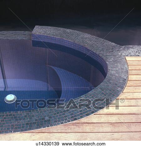 Stock Photo - Close-up of curved swimming pool with turquoise tiled edging. Fotosearch