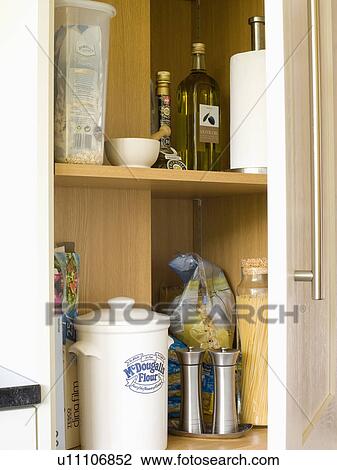 Close-up of door open to storage jars and pepper and salt pots in kitchen cupboard View Large Photo Image Stock Image - Close-up of door open to storage jars and pepper and salt pots in kitchen cupboard. Fotosearch