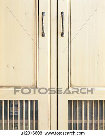 Stock Photo - Close-up of doors on cream kitchen storage cupboard. Fotosearch