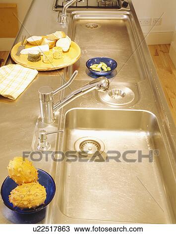 Close-up of double stainless steel sinks and mixer tap View Large Photo Image Stock Image - Close-up of double stainless steel sinks and mixer tap. Fotosearch