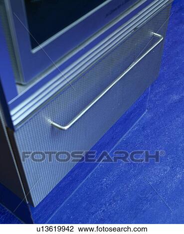 Stock Image - Close-up of drawer and blue Marmoleum flooring. Fotosearch