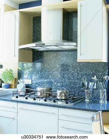 Close-up of extractor and blue wall tiles above fitted hob View Large Photo Image Stock Image - Close-up of extractor and blue wall tiles above fitted hob. Fotosearch