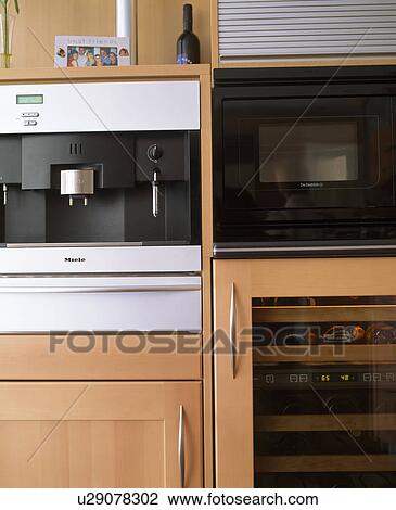 Close-up of fitted expresso coffee machine beside oven View Large Photo Image Stock Image - Close-up of fitted expresso coffee machine beside oven. Fotosearch