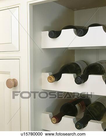Stock Image - Close-up of fitted wine rack. Fotosearch