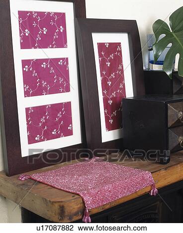 Stock Image - Close-up of framed embroidered pink silk fabric. Fotosearch