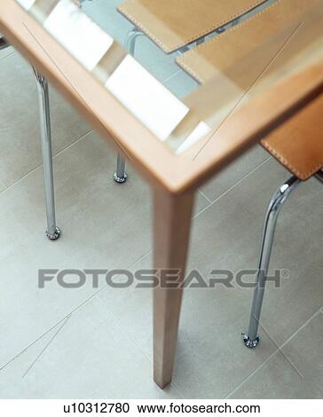 Close-up of glass and wood table on limestone floor View Large Photo Image Stock Image - Close-up of glass and wood table on limestone floor. Fotosearch
