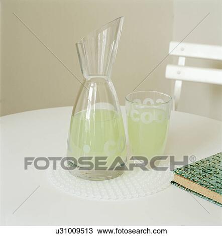 Close-up of glass carafe and water-glass on white table View Large Photo Image Stock Image - Close-up of glass carafe and water-glass on white table. Fotosearch