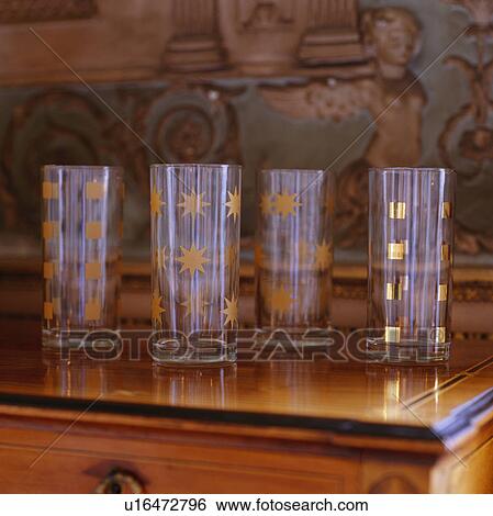 Stock Photograph - Close-up of glass tumblers decorated with hand-painted stars and squares. Fotosearch