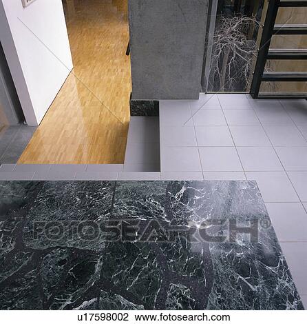 Close-up of granite inset in white ceramic tiled floor View Large Photo Image Stock Image - Close-up of granite inset in white ceramic tiled floor. Fotosearch