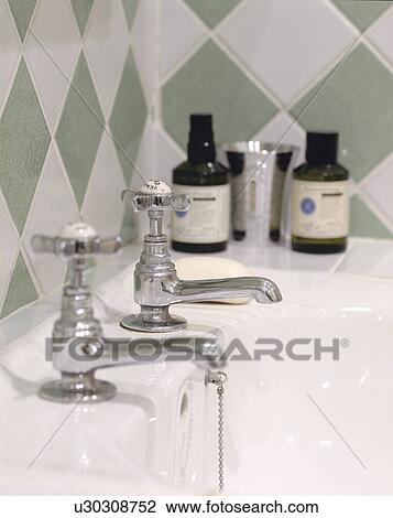 Close up of green and white diamond pattern tiles above chrome taps and toiletries on white bath View Large Photo Image Stock Image - Close up of green and white diamond pattern tiles above chrome taps and toiletries on white bath. Fotosearch