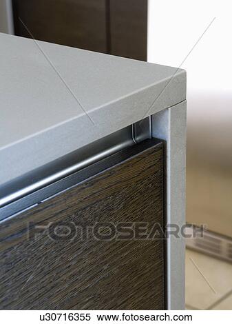 Stock Photography - Close-up of grey and dark brown kitchen unit. Fotosearch