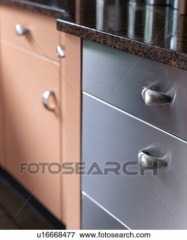 Close-up of grey and pink units in modern kitchen View Large Photo Image Stock Photo - Close-up of grey and pink units in modern kitchen. Fotosearch