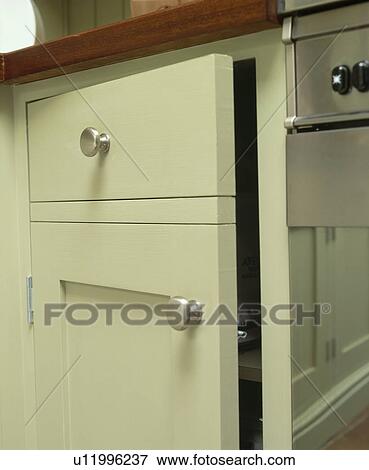 Stock Photo - Close-up of grey-green kitchen cupboard. Fotosearch