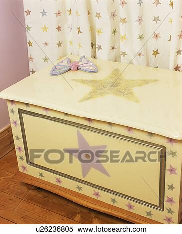 Stock Photography - Close-up of hand-painted star-themed cream wooden chest. Fotosearch