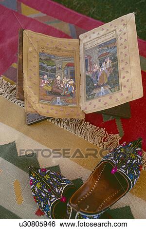 Close-up of illustrated antique Indian book and intricately embroidered Rajastani slippers View Large Photo Image Stock Photograph - Close-up of illustrated antique Indian book and intricately embroidered Rajastani slippers. Fotosearch