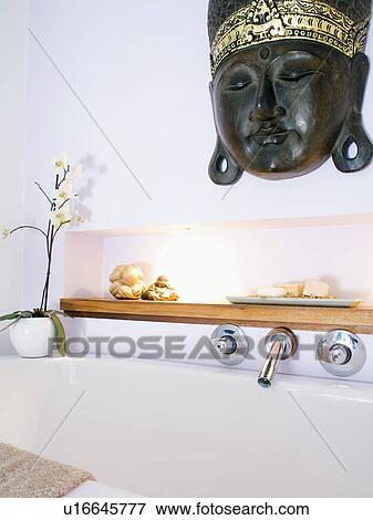 Stock Photo - Close-up of Indian mask above modern white bath. Fotosearch