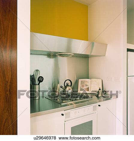 Close-up of kettle on hob in fitted unit with stainless steel worktop View Large Photo Image Stock Photo - Close-up of kettle on hob in fitted unit with stainless steel worktop. Fotosearch