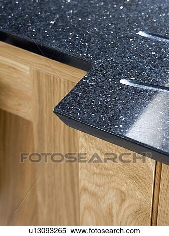 Close-up of kitchen unit with black granite worktop View Large Photo Image Stock Photography - Close-up of kitchen unit with black granite worktop. Fotosearch