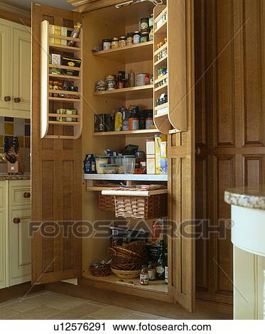 Stock Image - Close-up of larder cupbaord with doors open. Fotosearch