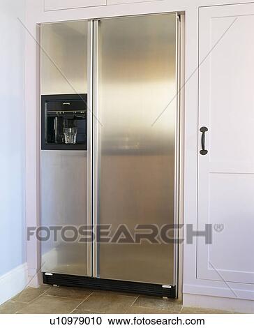 Stock Image - Close-up of large American-style stainless steel fridge-freezer. Fotosearch