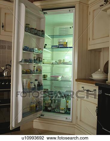 Stock Image - Close-up of large larder refrigerator with open door. Fotosearch