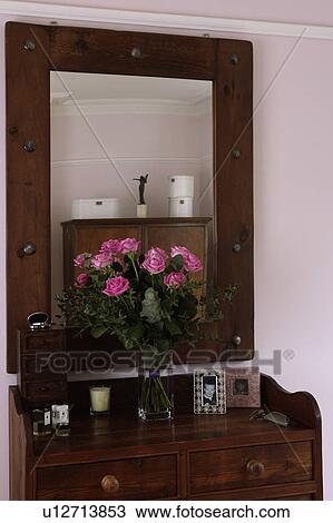Close-up of large mirrror above dressing-table with vase of pink roses View Large Photo Image Stock Image - Close-up of large mirrror above dressing-table with vase of pink roses. Fotosearch
