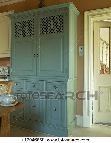 Close-up of large turquoise larder cupboard painted in Farrow+Ball paint in country kitchen View Large Photo Image Stock Photo - Close-up of large turquoise larder cupboard painted in Farrow+Ball paint in country kitchen. Fotosearch