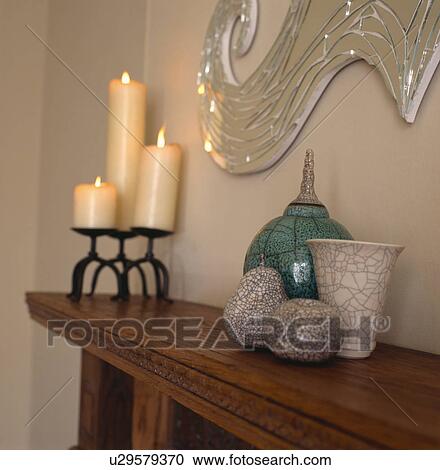 Close-up of lighted candles and crackle-glaze ornaments on mantelpiece View Large Photo Image Stock Image - Close-up of lighted candles and crackle-glaze ornaments on mantelpiece. Fotosearch