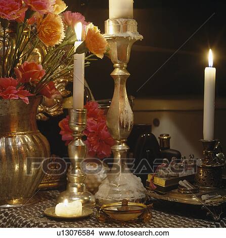 Close-up of lighted candles in brass candlesticks View Large Photo Image Picture - Close-up of lighted candles in brass candlesticks. Fotosearch