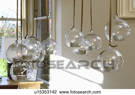Close-up of lighted candles in suspended glass globes View Large Photo Image Stock Image - Close-up of lighted candles in suspended glass globes. Fotosearch