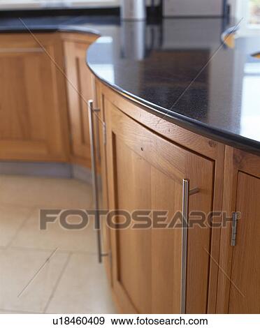 Stock Photo - Close-up of maple kitchen unit with black granite worktop. Fotosearch