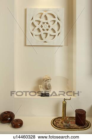 Stock Photo - Close-up of marble plaque above classical bust in cream alcove. Fotosearch