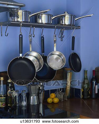 Close-up of metal saucepans hanging from metal shelf View Large Photo Image Stock Image - Close-up of metal saucepans hanging from metal shelf. Fotosearch